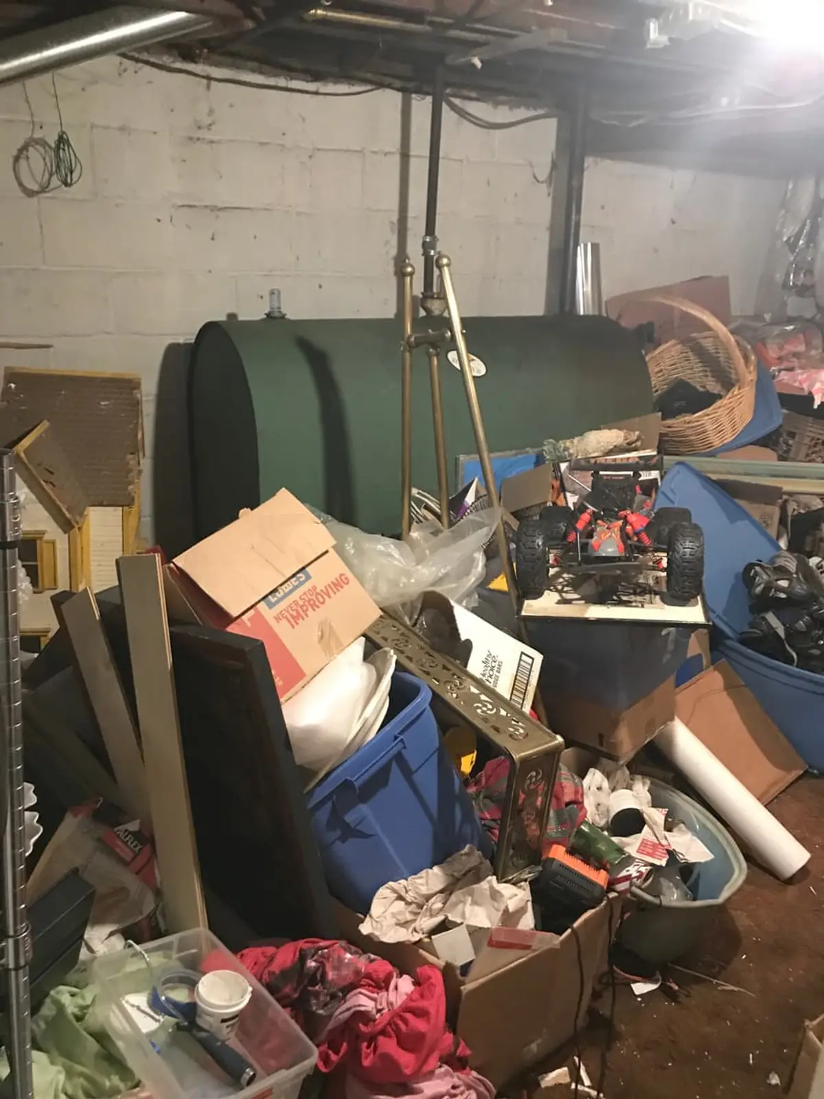 Selling a house with an oil tank in Bay Shore: basement oil tank buried behind boxes and bins