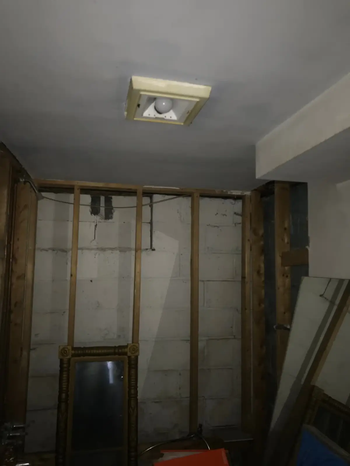 Selling a house with unpermitted work in Bay Shore: basement wall opened up to the bare studs