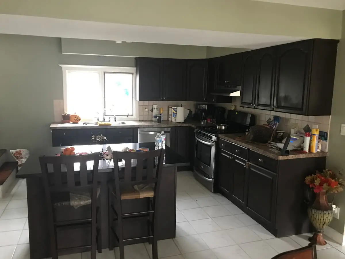 Selling a house during a divorce in Bay Shore: kitchen with dark wood cabinets and an island