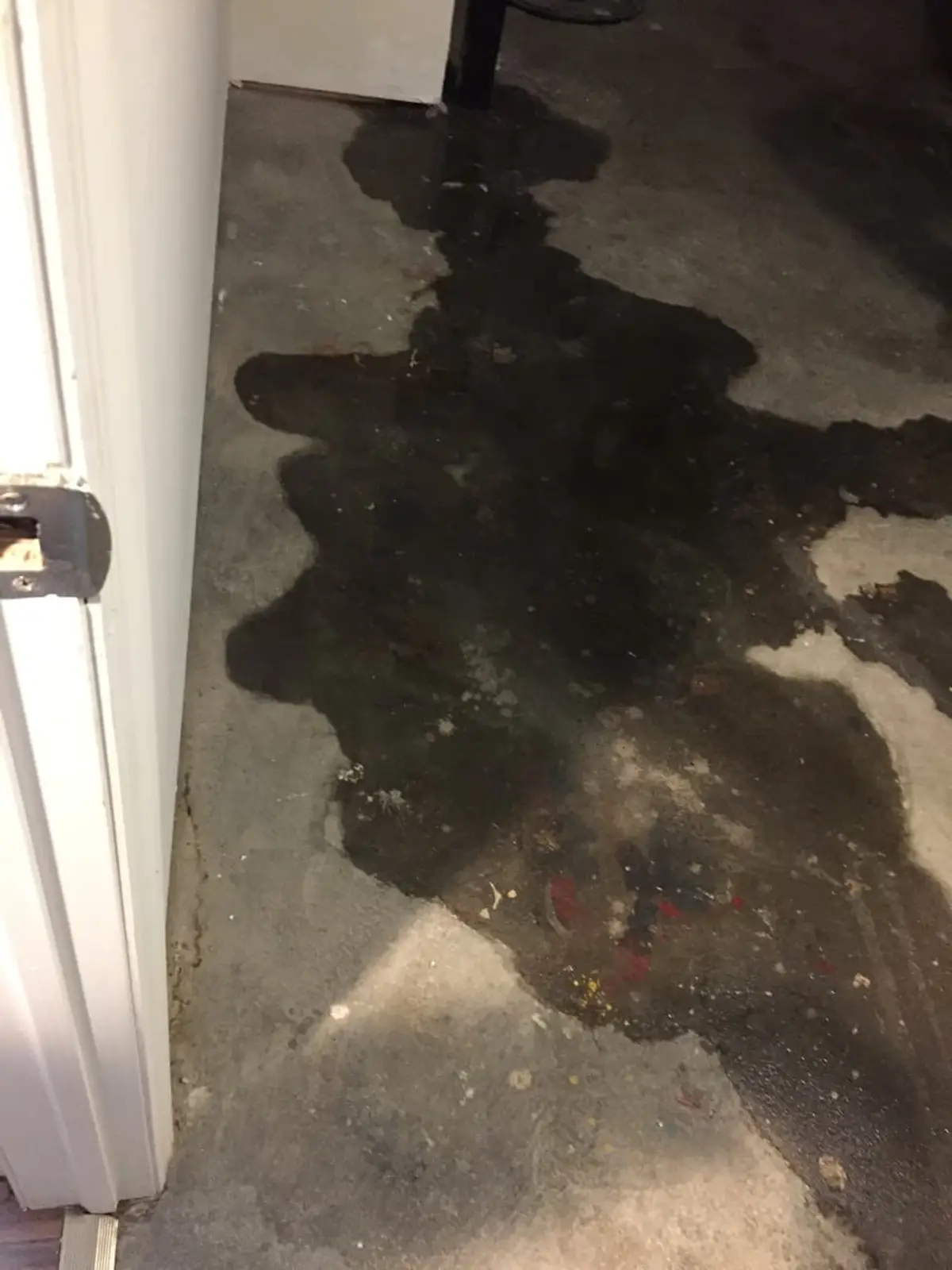 Selling a house in a flood zone in Bay Shore: water puddle spreading across a concrete floor